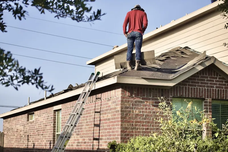 Professional roofer working on a residential roof in Granite